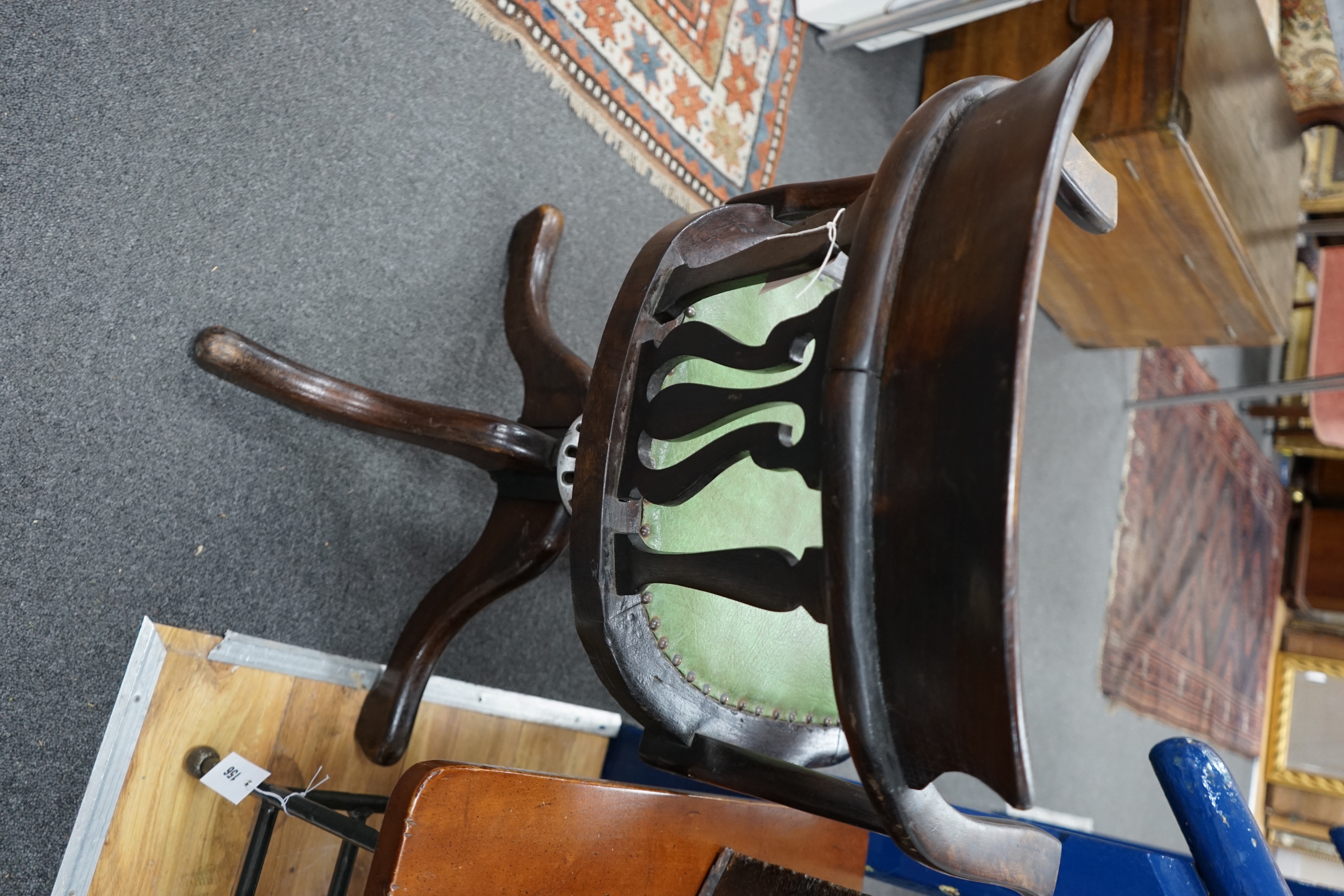 An Edwardian beech revolving office elbow chair